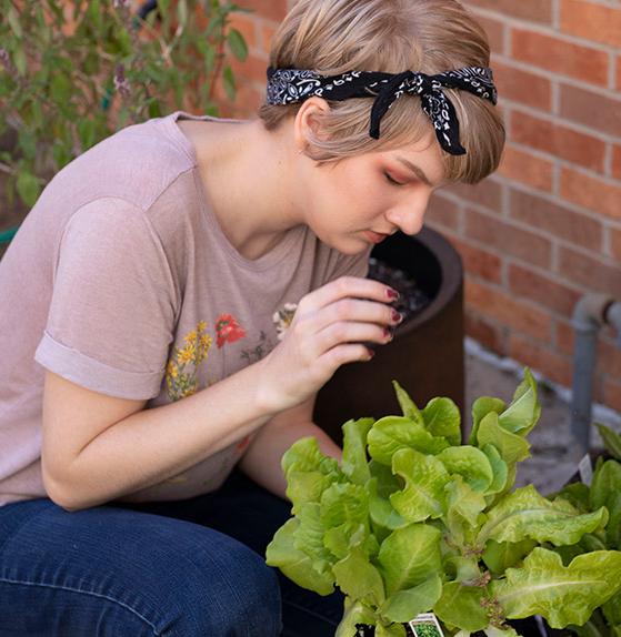 female student gardening